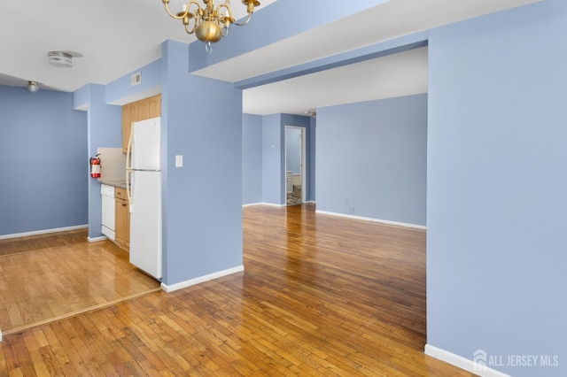 1724 Country Mill Dr, East Windsor, NJ 08512 - unfurnished room with a chandelier, light wood-style flooring, and baseboards