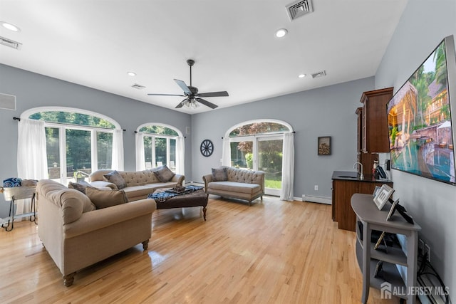 8 Garvey Dr, Monroe, NJ 08831 - living area featuring a baseboard radiator, light wood finished floors, recessed lighting, and a ceiling fan