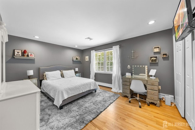 8 Garvey Dr, Monroe, NJ 08831 - bedroom featuring a baseboard heating unit, light wood-style flooring, recessed lighting, a desk, and a closet