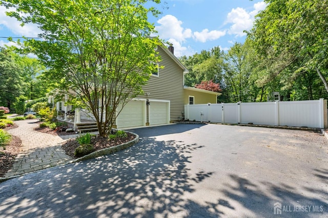 8 Garvey Dr, Monroe, NJ 08831 - view of home's exterior with driveway, a garage, and a gate