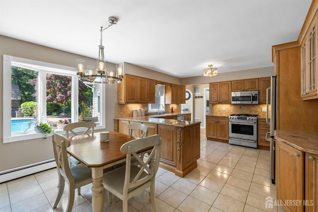 8 Garvey Dr, Monroe, NJ 08831 - kitchen featuring stainless steel appliances, a chandelier, tasteful backsplash, and brown cabinets