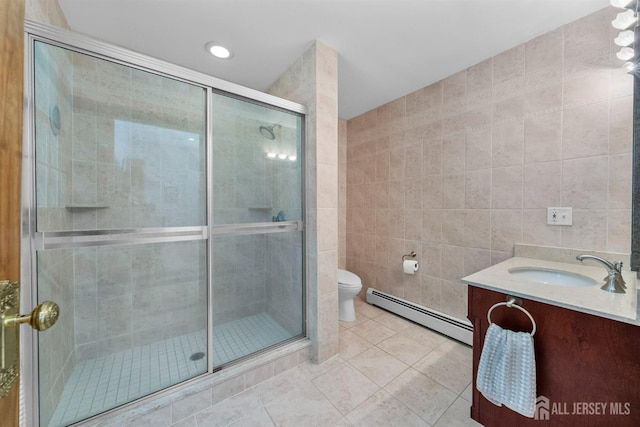 8 Garvey Dr, Monroe, NJ 08831 - bathroom with baseboard heating, tile walls, vanity, tile patterned flooring, and a shower stall