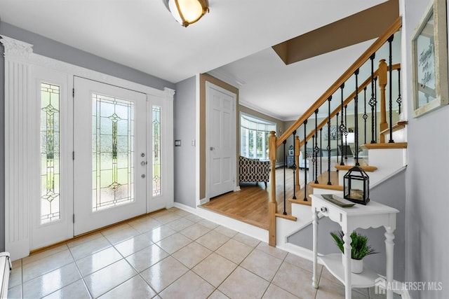 8 Garvey Dr, Monroe, NJ 08831 - foyer featuring stairway, tile patterned flooring, a baseboard radiator, and crown molding