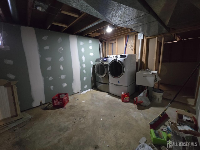 unfinished below grade area with independent washer and dryer and a sink