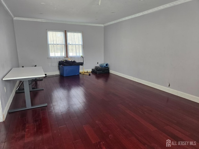 interior space featuring baseboards, crown molding, and hardwood / wood-style flooring