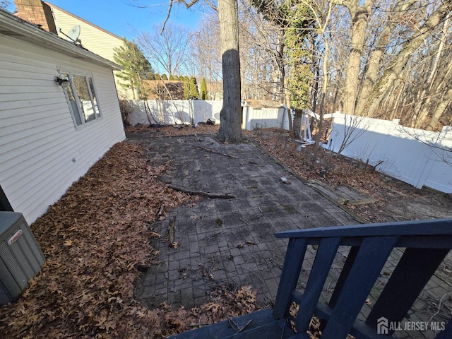 view of yard with central air condition unit, a patio, and a fenced backyard