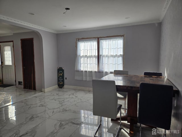 unfurnished dining area with baseboards, arched walkways, marble finish floor, and ornamental molding