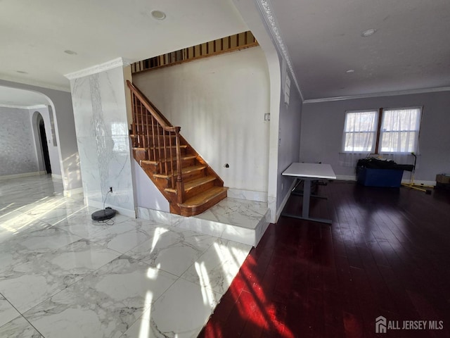 interior space with arched walkways, marble finish floor, stairs, and ornamental molding