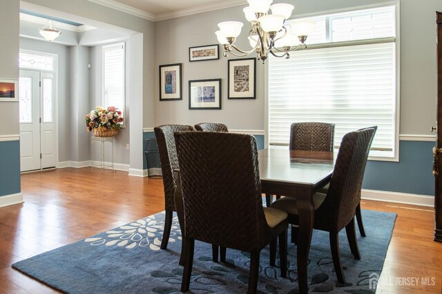 53 Mandrake Rd, Monroe, NJ 08831 - dining room featuring ornamental molding, a chandelier, wood finished floors, and baseboards