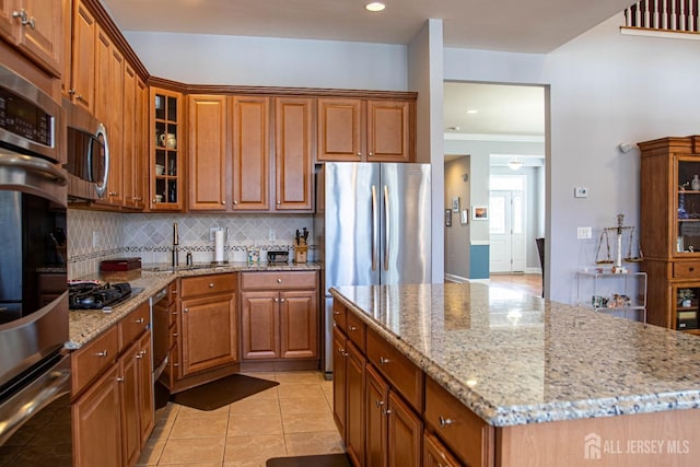 53 Mandrake Rd, Monroe, NJ 08831 - kitchen with decorative backsplash, brown cabinetry, light stone countertops, glass insert cabinets, and crown molding
