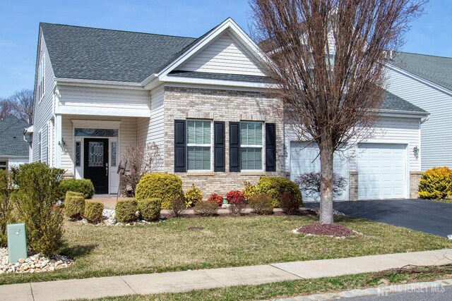 53 Mandrake Rd, Monroe, NJ 08831 - view of front of property featuring a garage, roof with shingles, a front lawn, and driveway
