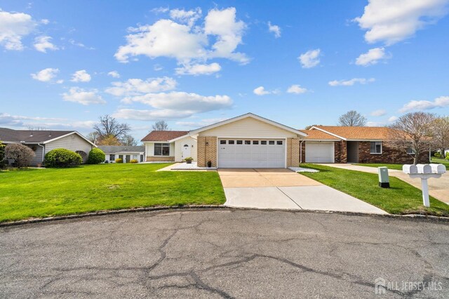 214 Branch Rd, Monroe, NJ 08831 - ranch-style house featuring an attached garage, a front yard, concrete driveway, and brick siding