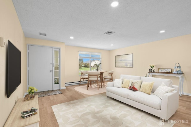 214 Branch Rd, Monroe, NJ 08831 - living room featuring baseboard heating, wood finished floors, recessed lighting, and a textured ceiling