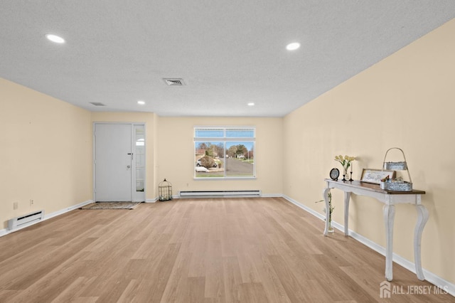 214 Branch Rd, Monroe, NJ 08831 - foyer entrance featuring baseboard heating, wood finished floors, baseboards, recessed lighting, and a textured ceiling