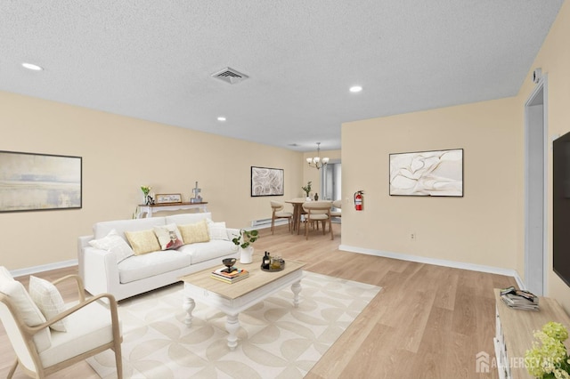 214 Branch Rd, Monroe, NJ 08831 - living room featuring light wood-style flooring, a chandelier, recessed lighting, baseboards, and baseboard heating