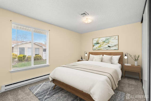 214 Branch Rd, Monroe, NJ 08831 - bedroom featuring baseboard heating, carpet floors, and a textured ceiling