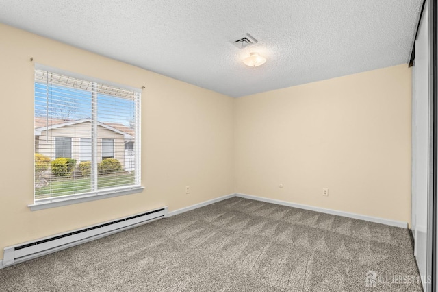 214 Branch Rd, Monroe, NJ 08831 - carpeted empty room with baseboard heating, a textured ceiling, and baseboards