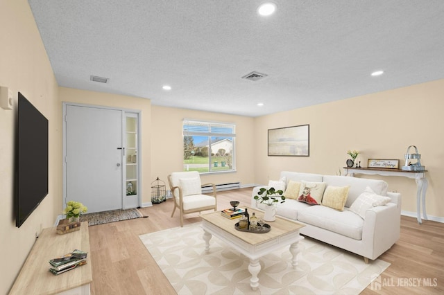 214 Branch Rd, Monroe, NJ 08831 - living room featuring light wood-style flooring, a textured ceiling, recessed lighting, a baseboard radiator, and baseboards