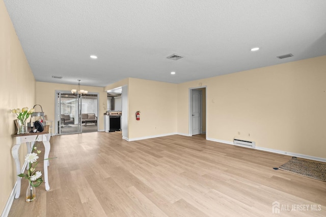 214 Branch Rd, Monroe, NJ 08831 - unfurnished living room featuring a chandelier, baseboard heating, light wood-type flooring, baseboards, and recessed lighting