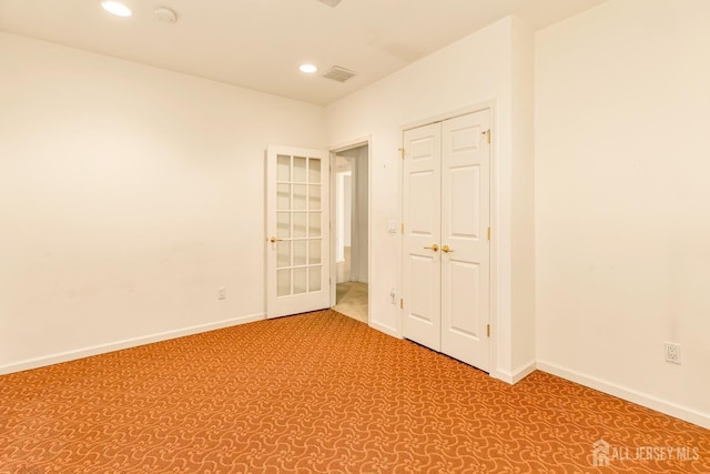 spare room with baseboards, recessed lighting, and carpet flooring