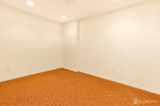 empty room featuring carpet flooring, baseboards, and recessed lighting
