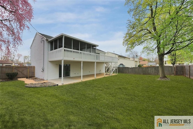 rear view of property with stairway, a sunroom, a patio, and a fenced backyard