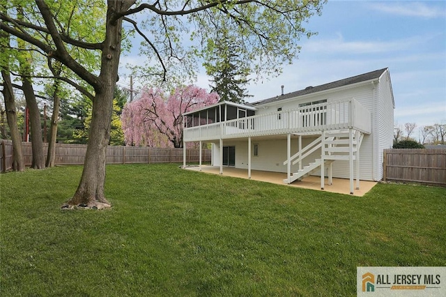 rear view of property featuring stairs, a wooden deck, a fenced backyard, a patio, and a yard