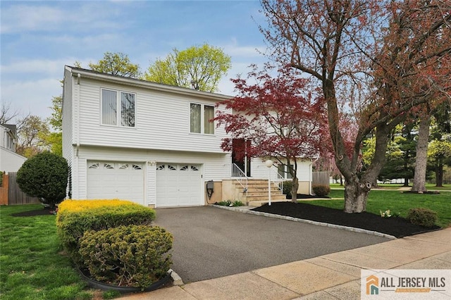 view of front facade featuring a garage, a front lawn, and aphalt driveway