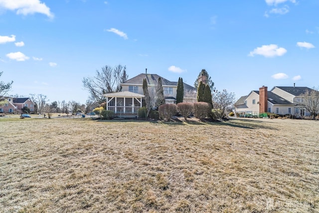 view of front of property featuring a sunroom