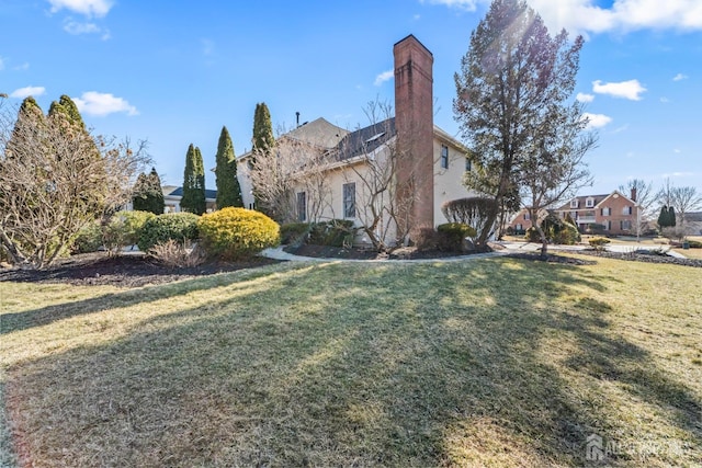 view of home's exterior with a yard