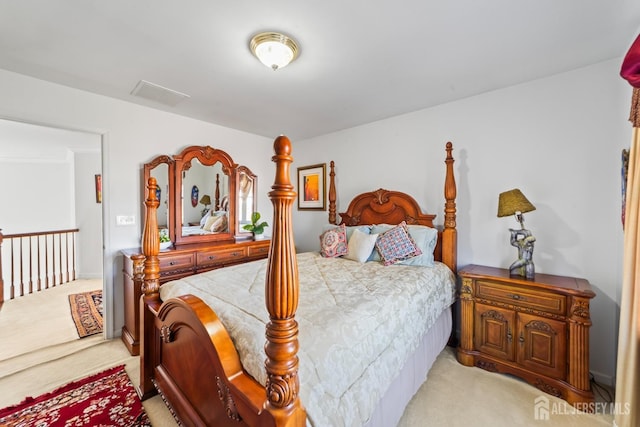 bedroom featuring light colored carpet and visible vents