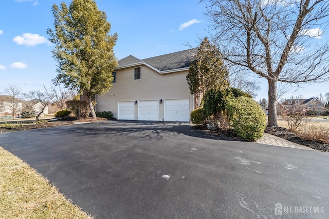 view of home's exterior with driveway and an attached garage