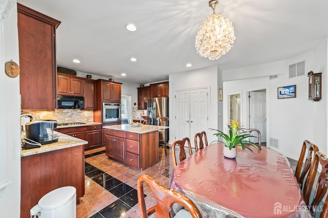 kitchen featuring appliances with stainless steel finishes, decorative backsplash, visible vents, and recessed lighting