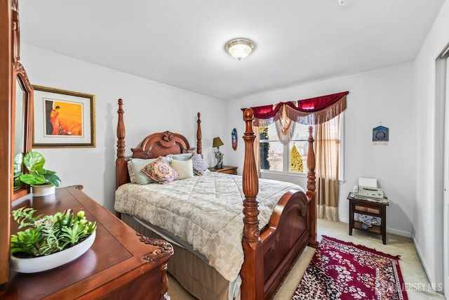 bedroom featuring light colored carpet and baseboards