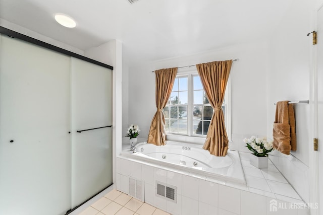 full bathroom featuring tile patterned flooring, visible vents, and a whirlpool tub