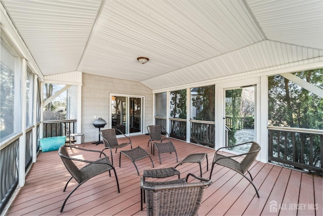 sunroom featuring vaulted ceiling and a wealth of natural light