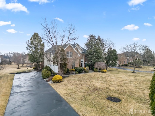 view of side of home with a yard