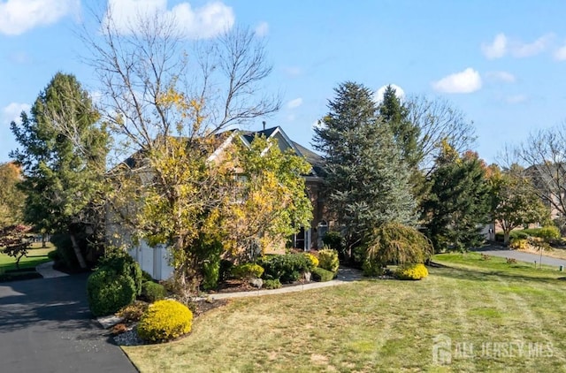 view of property exterior with a lawn