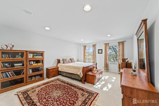 bedroom featuring light colored carpet and recessed lighting