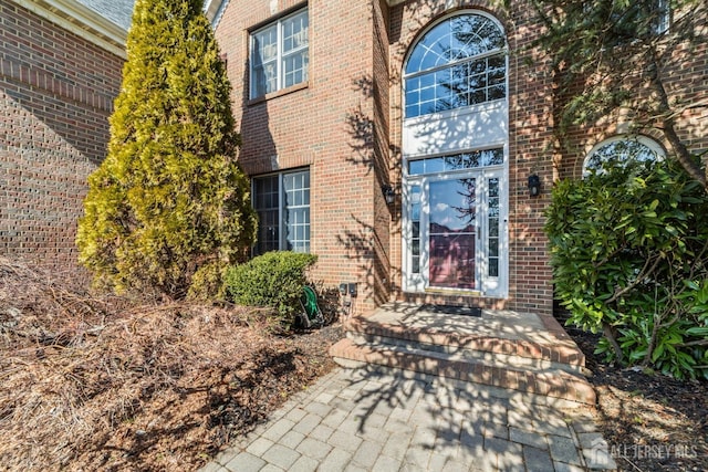 entrance to property with brick siding