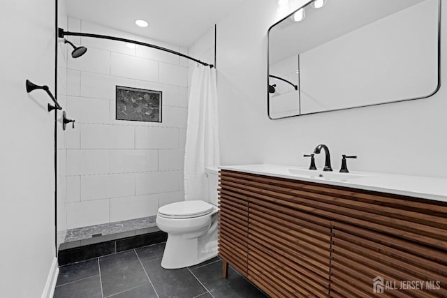 bathroom featuring recessed lighting, toilet, a tile shower, vanity, and tile patterned flooring