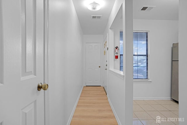 corridor featuring visible vents and baseboards