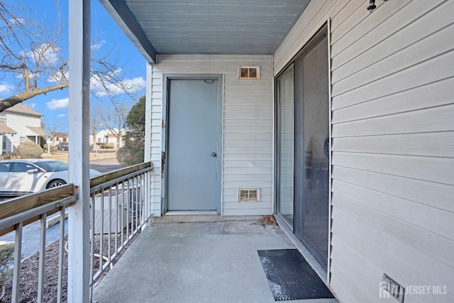 entrance to property featuring a balcony and a residential view