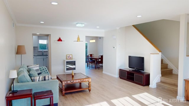 living room featuring recessed lighting, light wood-type flooring, stairs, and crown molding