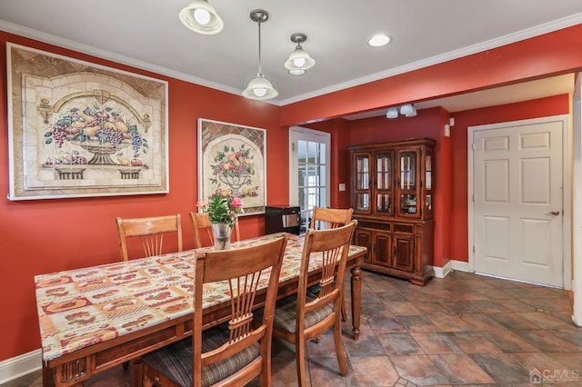 dining area with ornamental molding and baseboards