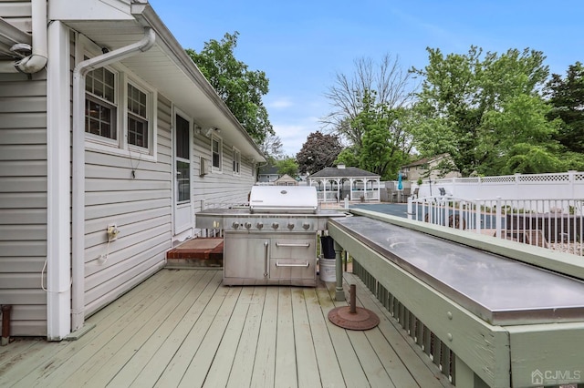 wooden terrace featuring fence