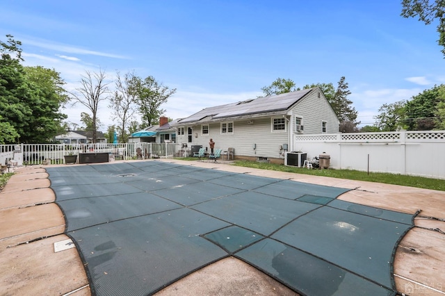 view of pool with a fenced backyard, a patio, and central AC