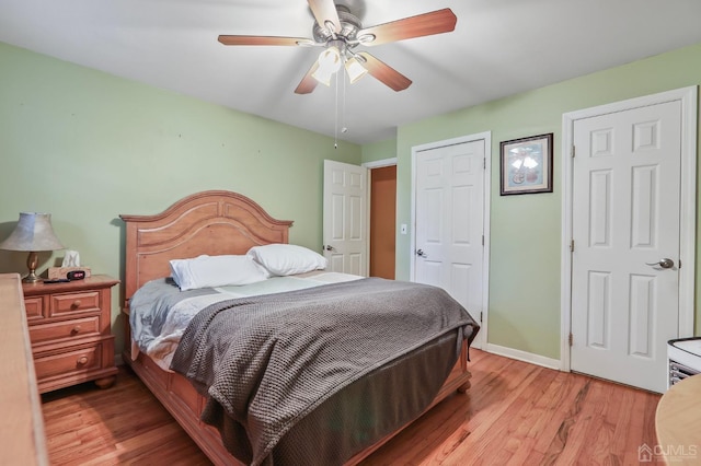 bedroom featuring light wood-style floors, baseboards, and a ceiling fan