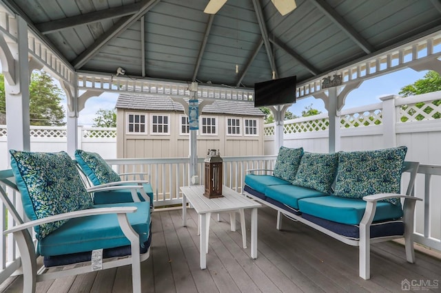 wooden deck featuring fence, an outdoor hangout area, and a gazebo