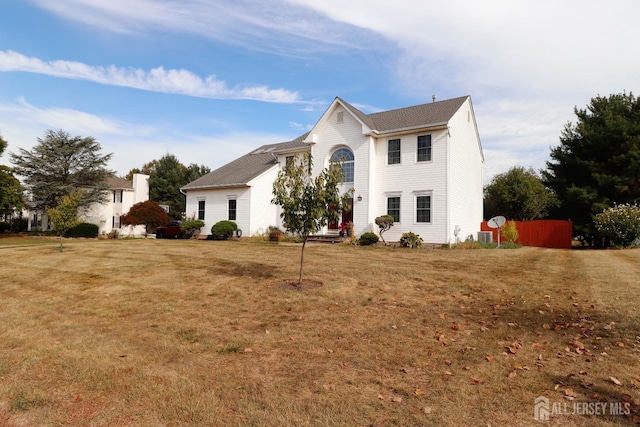 colonial home featuring a front lawn